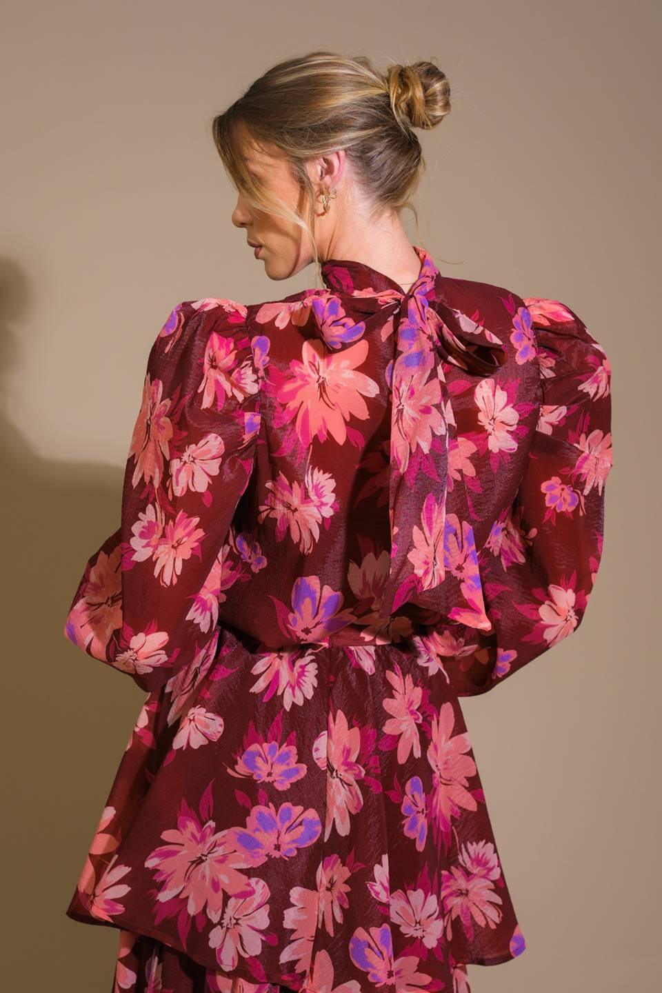 Close-up of burgundy floral woven top with bow detail