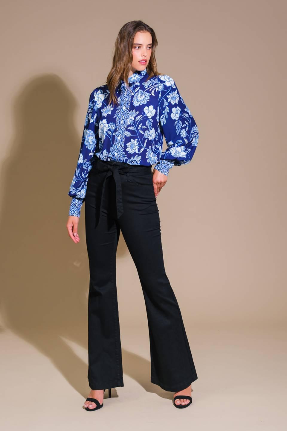 Navy floral woven top styled with black pants, side view