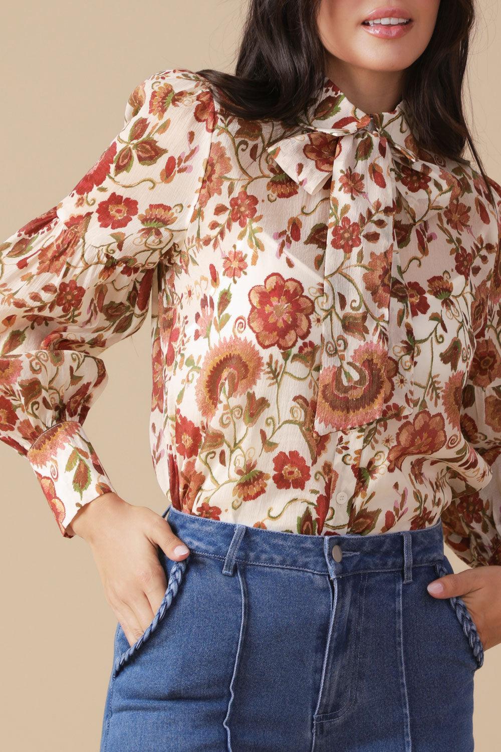 Close-up of ivory floral woven blouse with bow detail