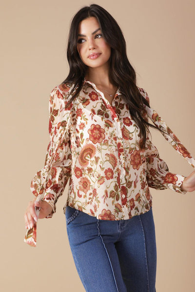 Ivory floral blouse with bow, model adjusting sleeves