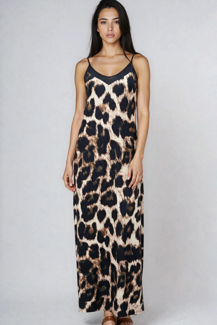 Woman wearing a leopard print dress on a plain background