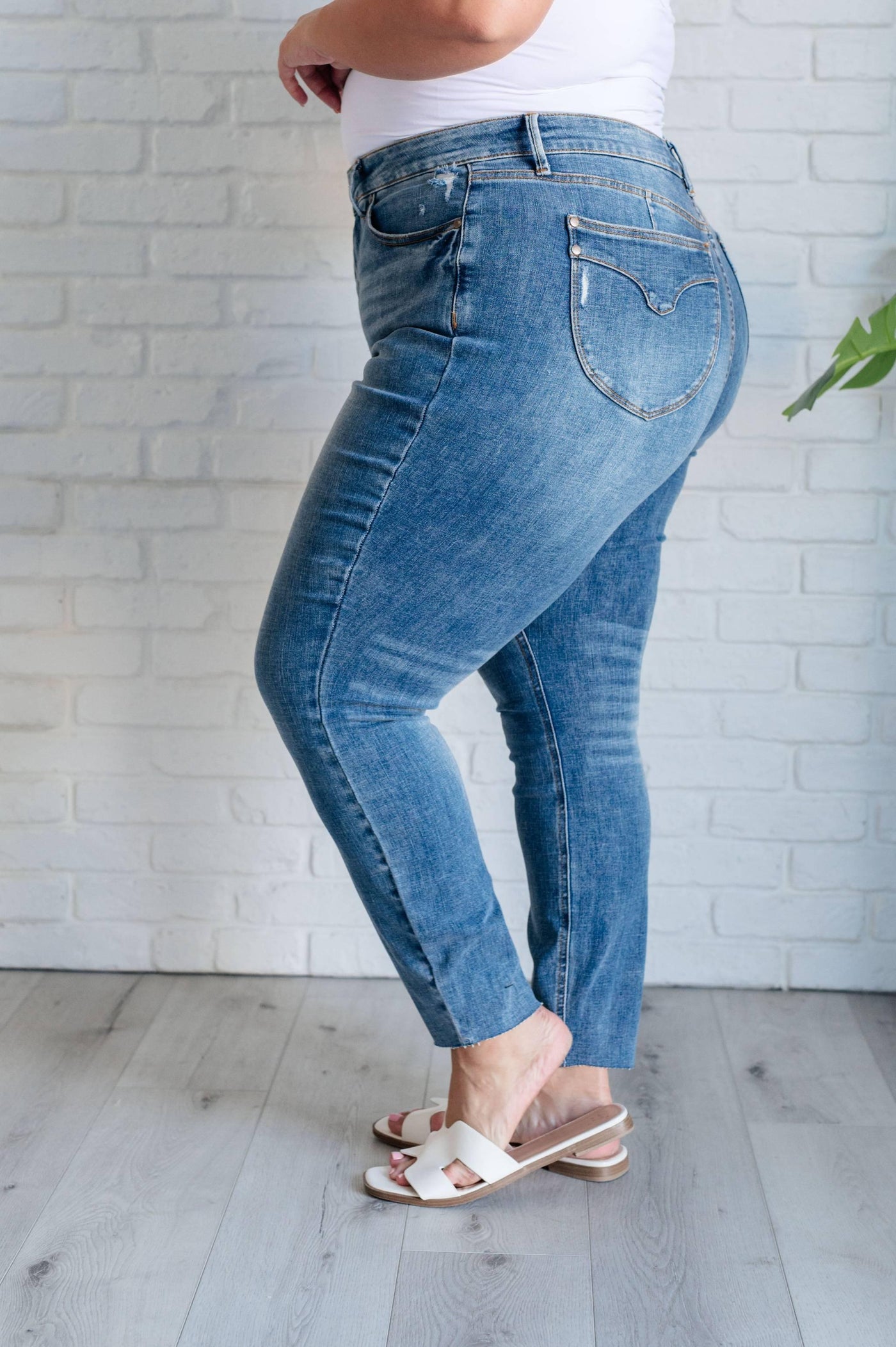 Plus size side view of Nicole Tummy Control Skinny Jeans