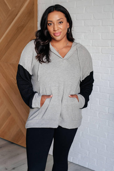 Gray hoodie with black sleeves, front view