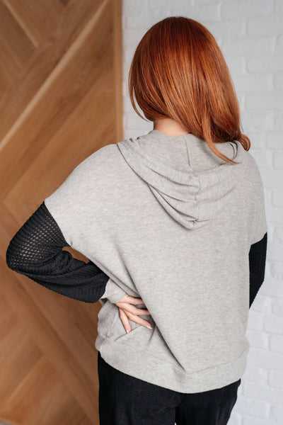 Back view of gray hoodie with black sleeves