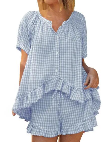 Woman wearing a blue checkered pajama set on a white background