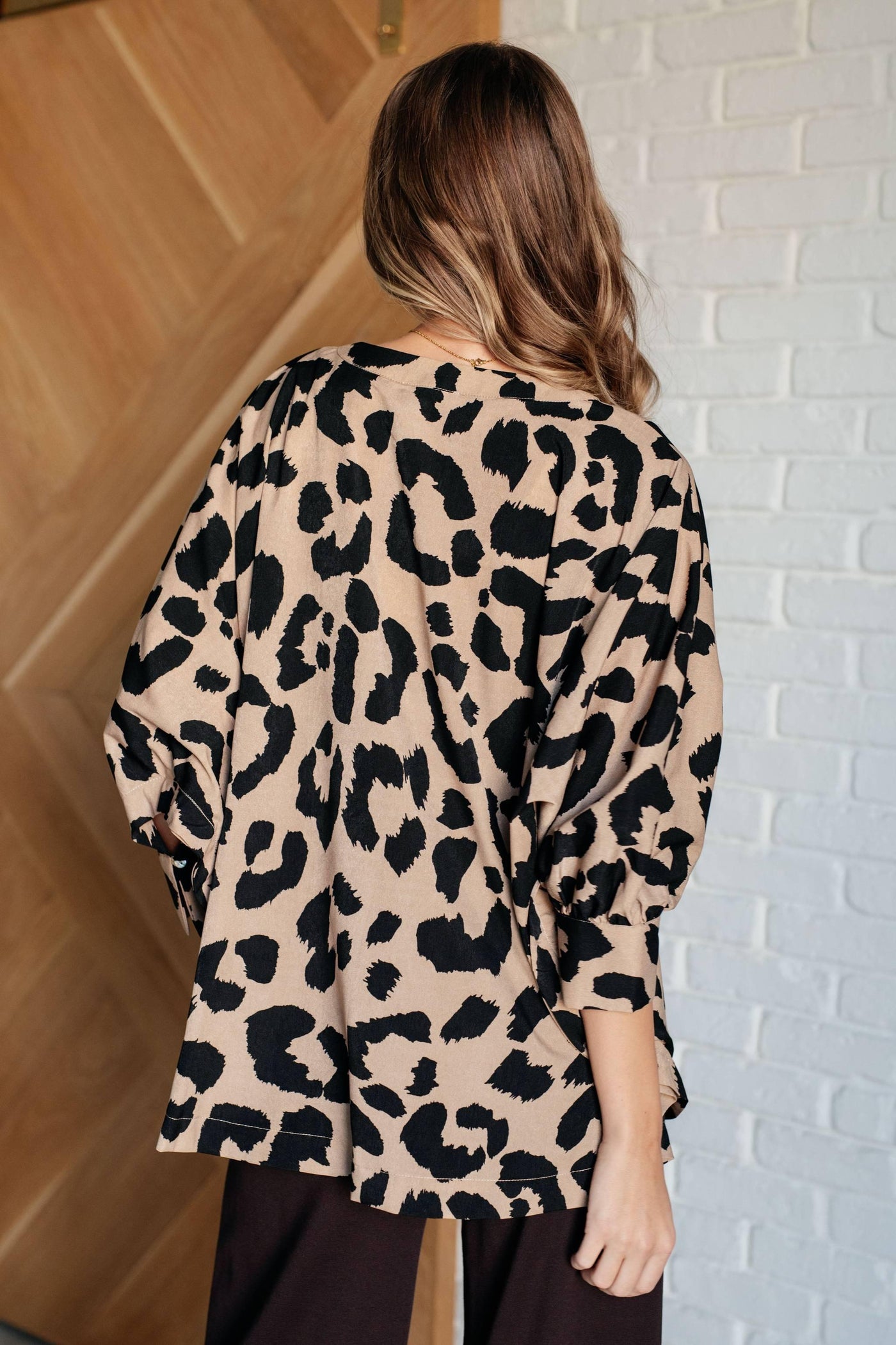 Back view of batwing blouse with animal print.