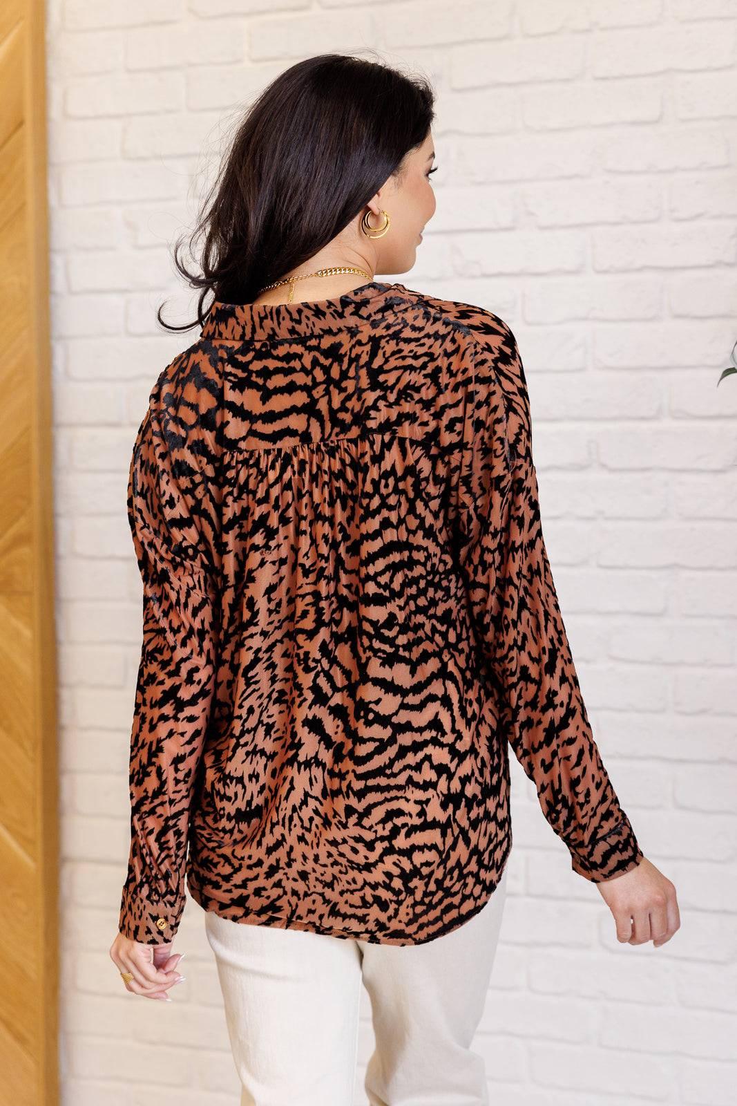 Back view of Animal Print Blouse with white jeans