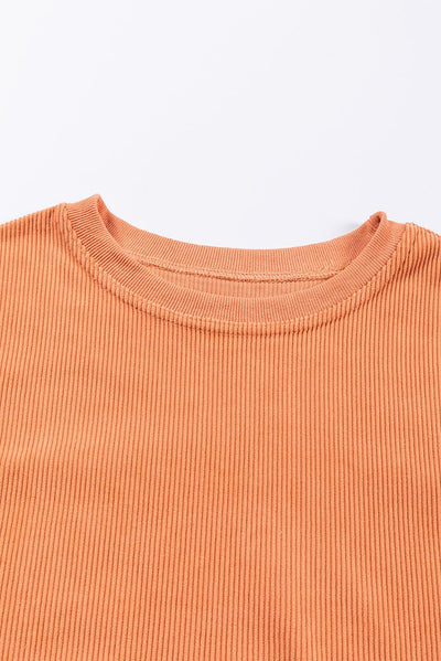 Sleeve detail of orange ribbed corduroy sweatshirt