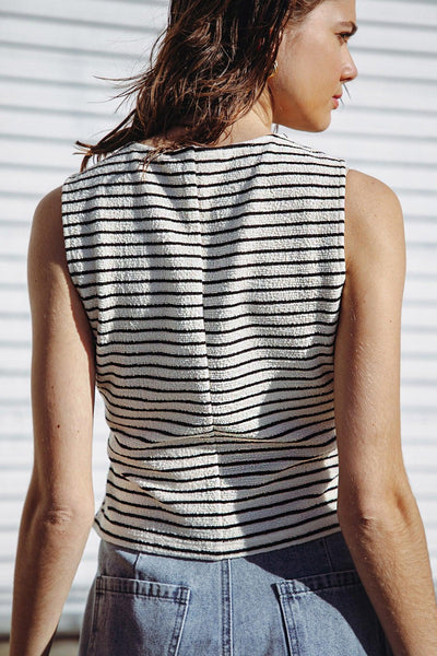 Back view of cream and black striped knit vest.