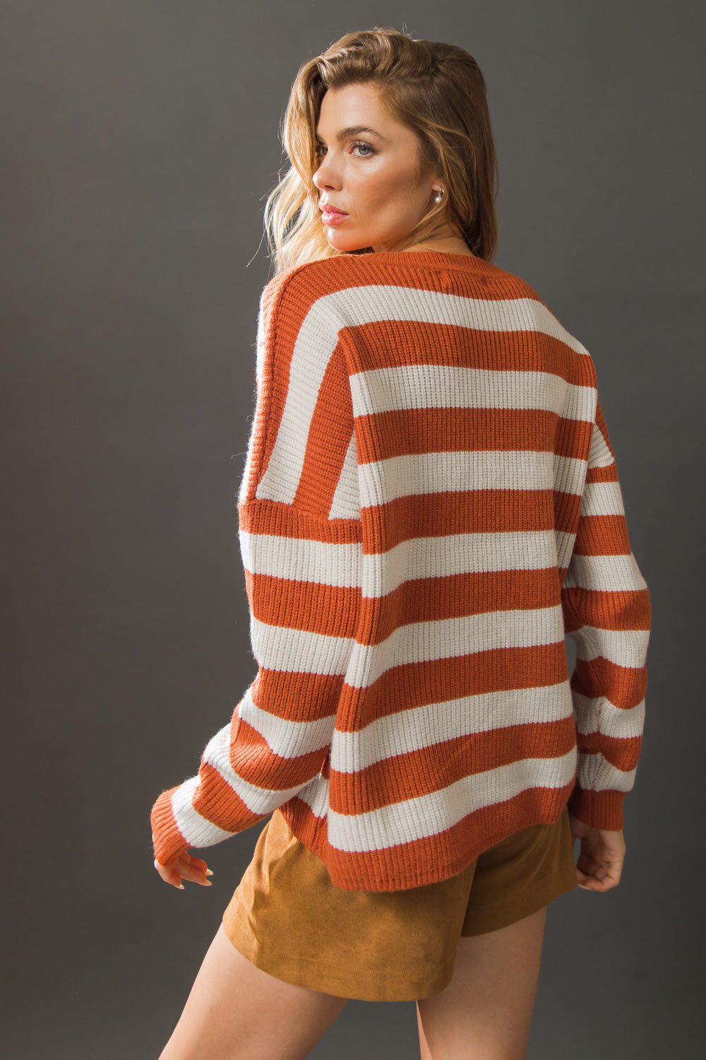 Back view of rust and ivory striped sweater top