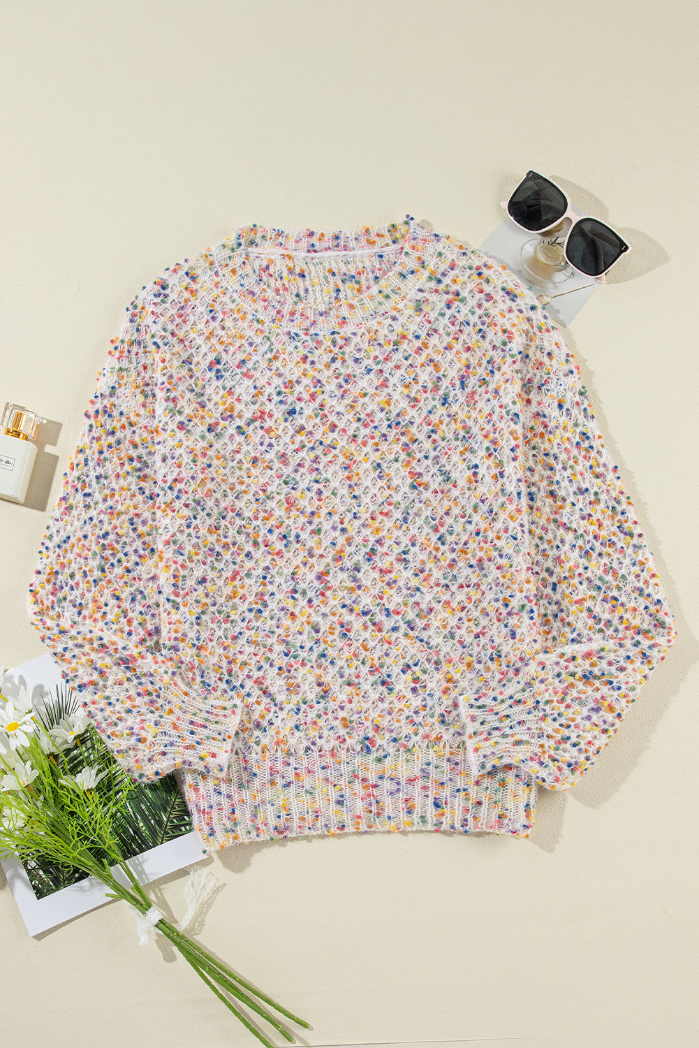 Flat lay of white confetti knit popcorn sweater top