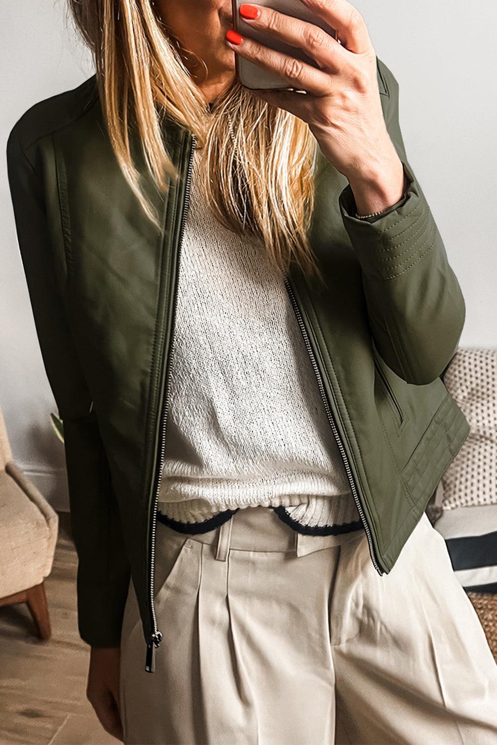 Sage green faux leather bomber jacket worn with beige pants