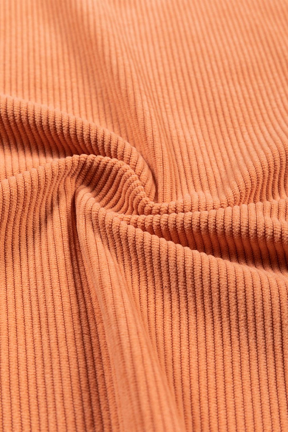 Stitching detail on orange ribbed sweatshirt