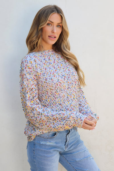 Model wearing white confetti knit popcorn sweater top