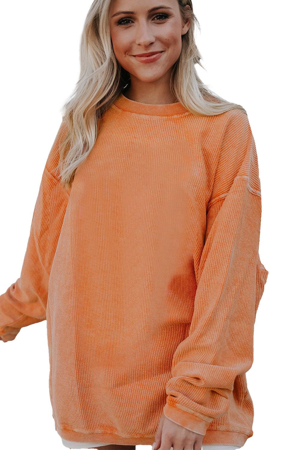 Orange ribbed sweatshirt with necklace and bag