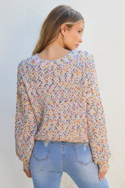 Back view of white confetti knit popcorn sweater top