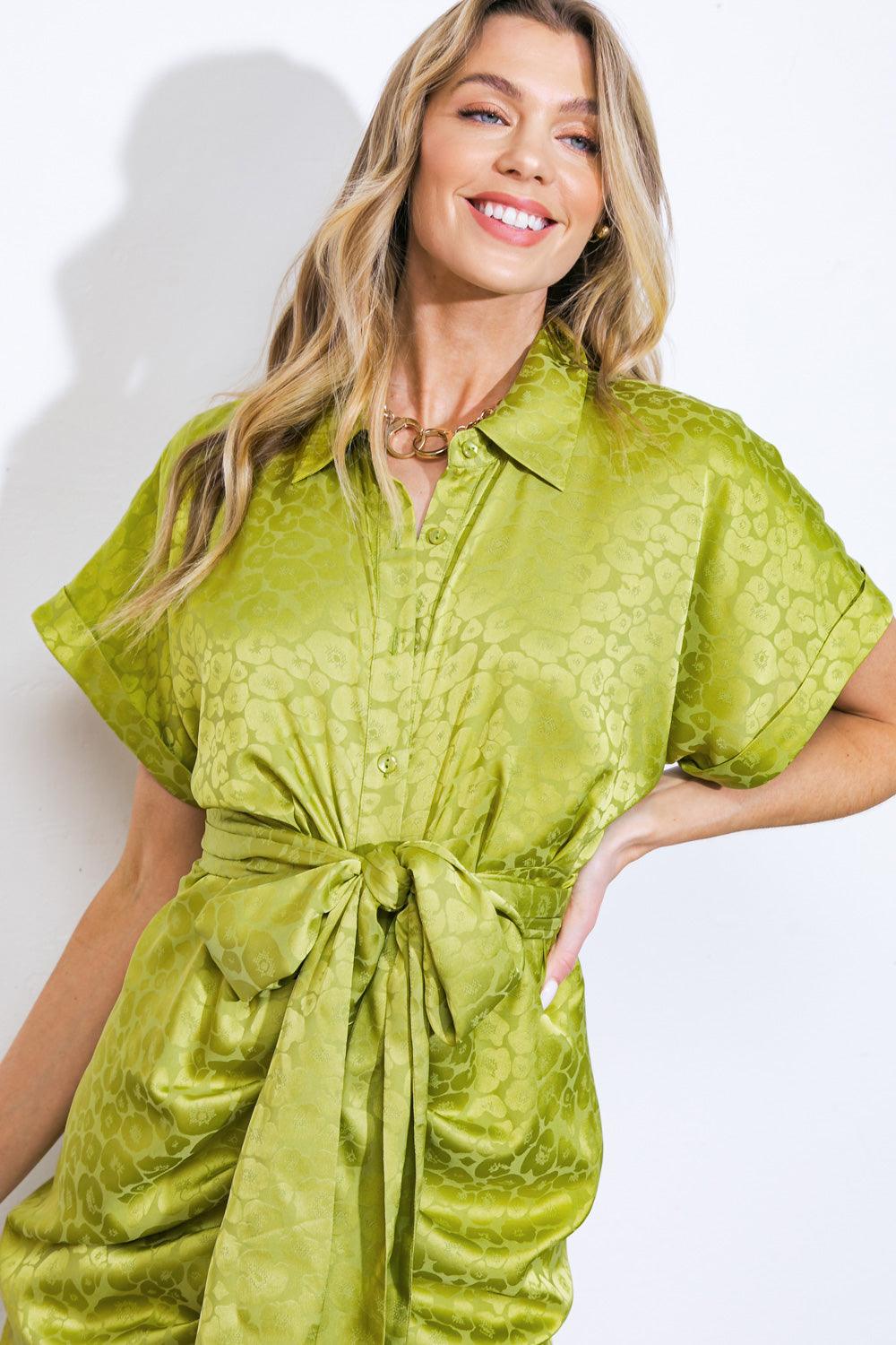 Close-up of yellow green satin dress with button-up front