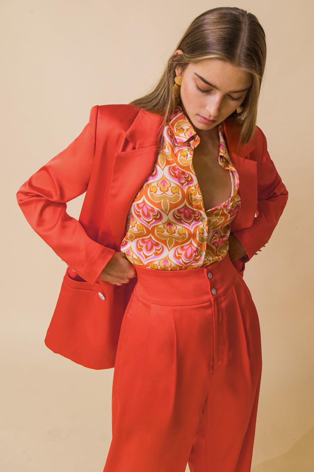 Orange blazer with patterned blouse and pants