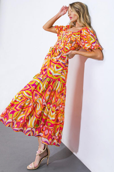 Fuchsia lime woven midi dress with vibrant pattern, angled pose