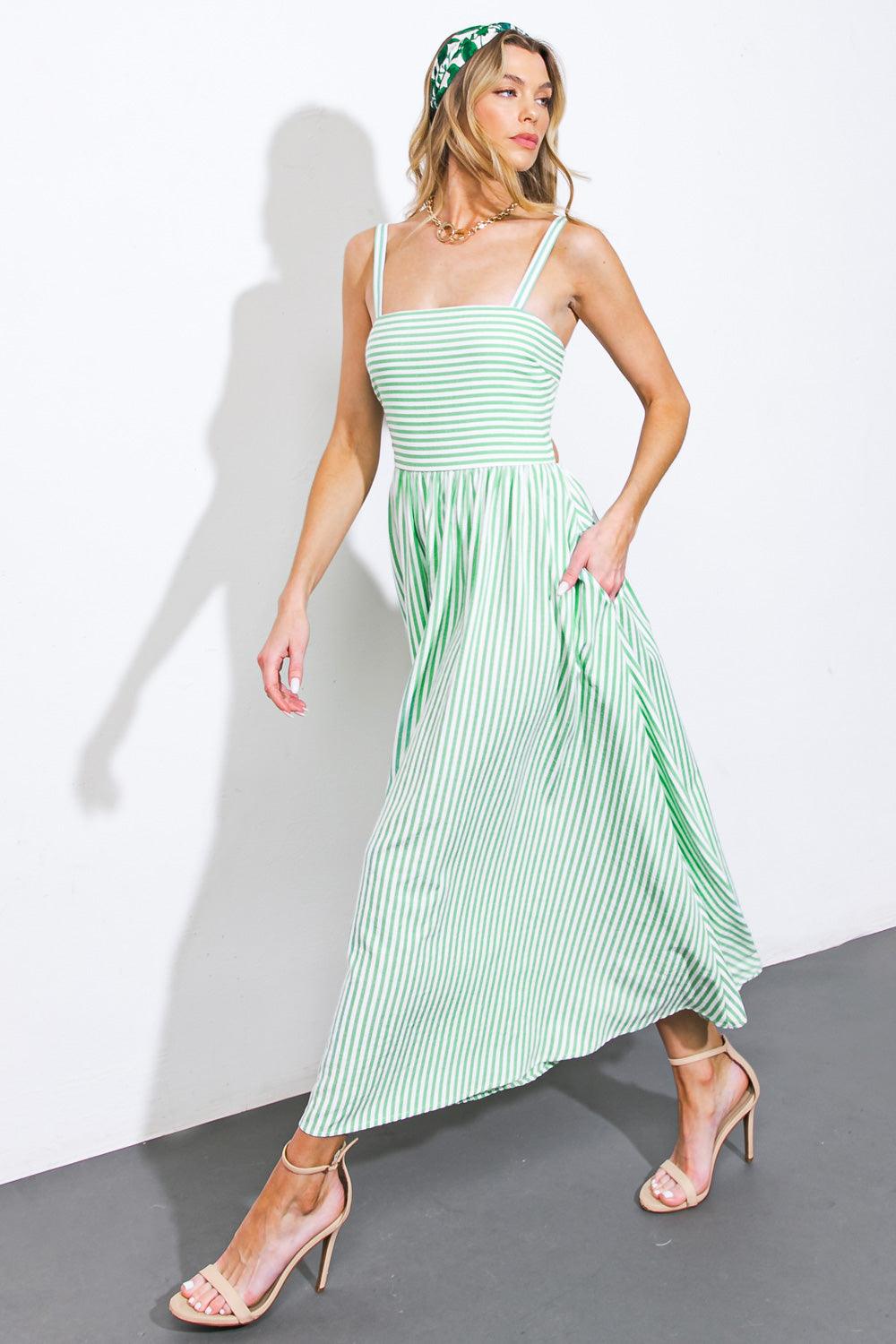 Model walking in green striped woven midi dress