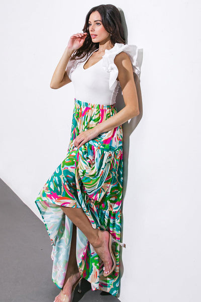 Model wearing vibrant woven maxi skirt with ruffled top.